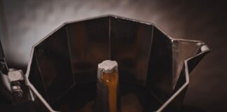 Zbliżenie na parzenie espresso w stalowej kawiarce Moka